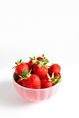 Bowl with fresh strawberries on white background. Summer composition