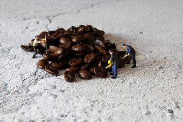 Humorous still life image  of workmen preparing coffee beans