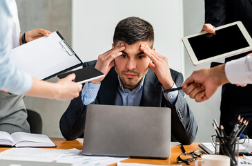 Stressed Businessman Tired Of Tasks Sitting At Work In Office