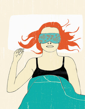 Woman in bed wearing sleep mask
