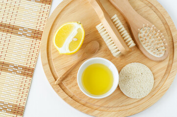 Lemon juice and lemon slice, loofah sponge, wooden hairbrush and massage body brush. Ingredients...