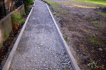 the construction of a pedestrian sidewalk begins with the dredging of the road bed and the setting...