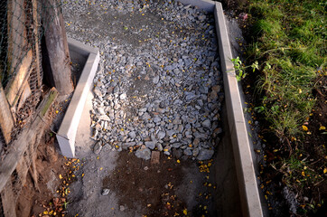 the construction of a pedestrian sidewalk begins with the dredging of the road bed and the setting...