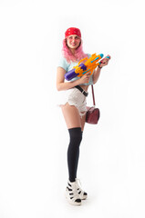 girl with a water gun in summer clothes, slim and sexy isolated on a white background