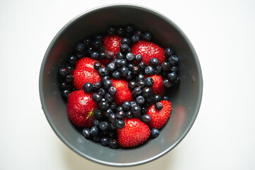 assorted fresh strawberries and
blueberries
 in a round plate