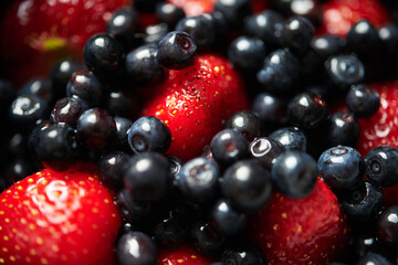 
assorted fresh strawberries and
blueberries macro
