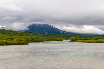 Daytime view of the lake in windy weather. With a view of the volcano on the horizon. A view from...