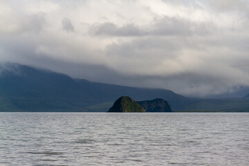Daytime view of the lake in windy weather. With a view of the volcano on the horizon. A view from...