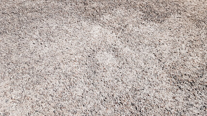 Crushed gravel texture background in natural light. Fine gray gravel for background or texture. Natural building material for road construction or landscape architecture. Construction industry