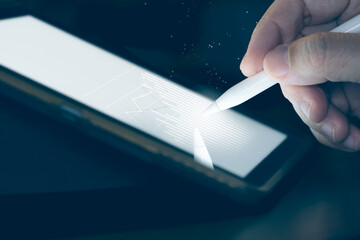 Hand use  pen stylus touch business graph  on Tablet screen Mock up with light. Concept for mobile...