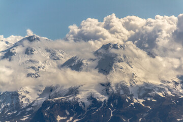 Obraz premium Daytime view in clear sunny weather of the snow-capped mountain peaks