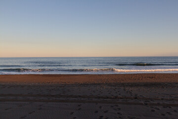 View of the Pacific coast during a sunny sunset on a clear sunny day.