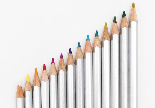 Closuep shot of an accending row of colorful pencils with silver covers
