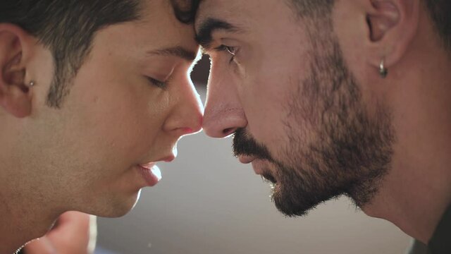Gay boy couple look into each other's eyes. LGBT