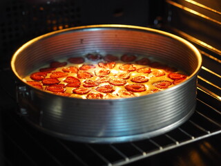 Homemade baking.Strawberry biscuit cake is baked in a baking dish in the kitchen oven.