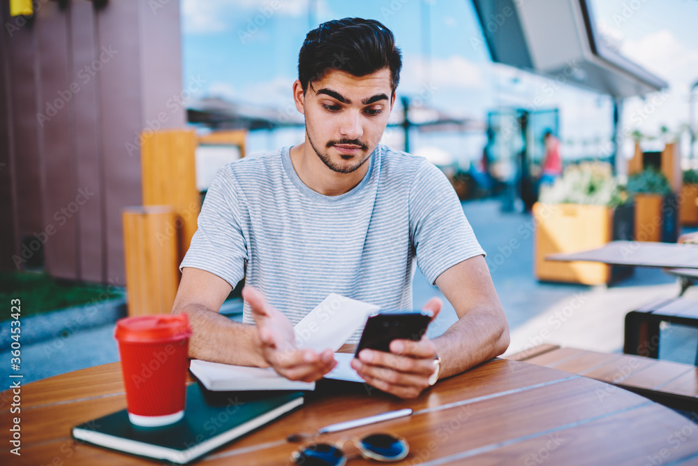 Aufkleber skeptical male blogger amazed with incoming notification with strange message about interner changes