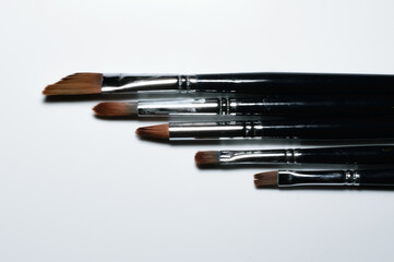 Painting brushes are kept side by side in descending order. White background