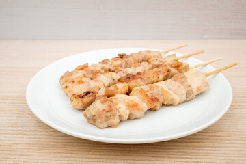 Chicken leg skewers on white background