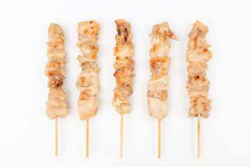 Chicken leg skewers on white background