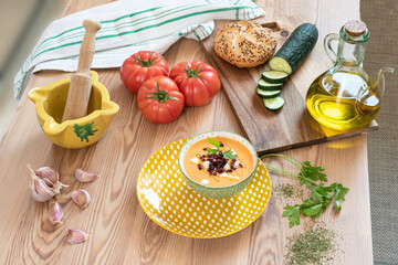 Bowl with salmorejo and its ingredients. Typical Spanish food. Top view.