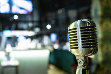 Vintage microphone on stage in a restaurant on a blurred background.