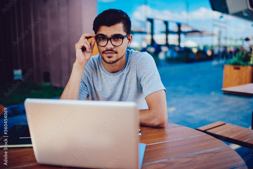 Poster portrait of skilled bearded programmer working on creating software having experience in development