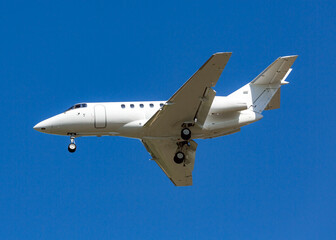 White business jet plane in the sky