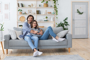 Photo of relaxed man and woman spending weekend at home