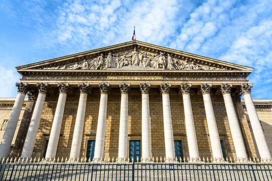 Low angle view of the neoclassical facade of the Palais Bourbon, with portico, colonnade and pediment, seat of the french National Assembly (Assembl&eacute;e Nationale) in Paris, France.