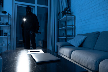 Intruder breaking in an apartment or office to steal something