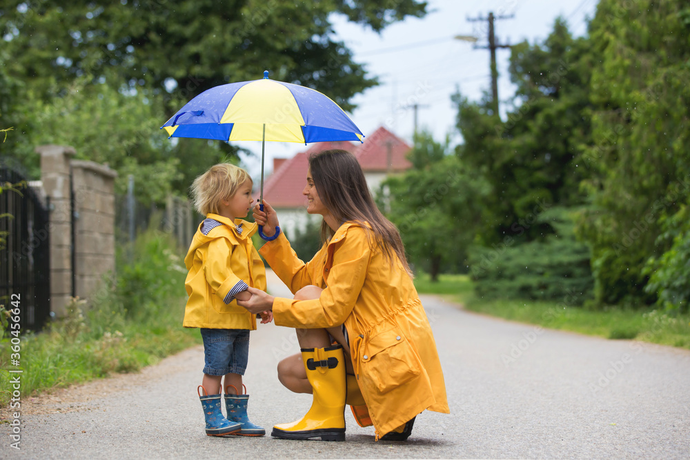 Sticker Mother and toddler child, boy, playing in the rain