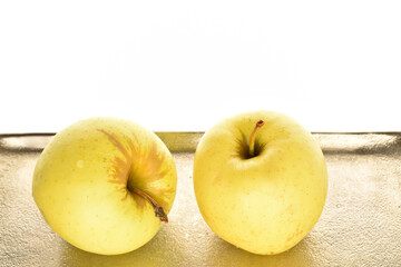 Yellow apples, close-up, on a white background.