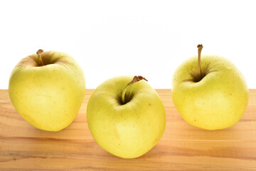 Yellow apples, close-up, on a white background.
