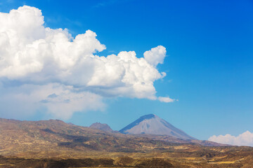Obraz premium Panoramic view Little Ararat Mount in clear weather. Rocky mountain slopes. Lava stones and desert near Mount Ararat in eastern Turkey, Agri Province