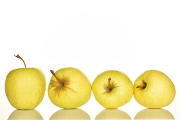Yellow apples, close-up, on a white background.