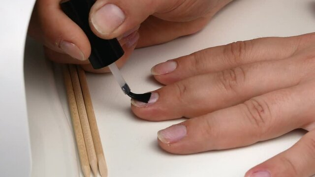 Application of the primer to the nail plate.Gel nail Polish at home.