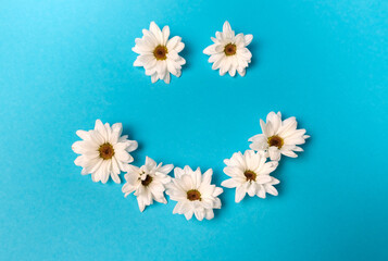 Smiley lined with daisies on a blue background