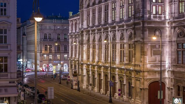 Beautiful view of Wiener Staatsoper (Vienna State Opera) aerial day to night transition timelapse in Vienna, Austria. Illuminated historic buildings and traffic on streets