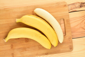 Yellow banana, close-up, on a wooden table.