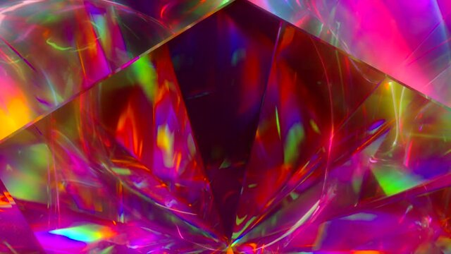 The light passes through the facets of a slowly rotating diamond and creates repetitive sparkling highlights and bright rainbow colors