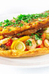Hot breakfast. Omelette with seafood and vegetables.