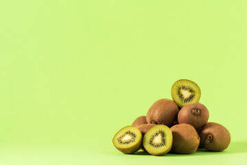 Green kiwis ripen on a tree. Kiwis on a branch. Healthy. Rich in vitamins.