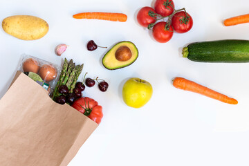 Paper bag of different healthy foods on a white background. Top view with copy space. Flat view.