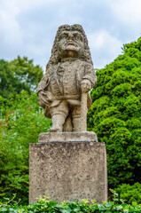 Fototapeta na wymiar Statue of a male dwarf (carved by workshop of baroque sculptor Matthias Bernard Braun) in the park of the castle, Nove Mesto nad Metuji, Czech republic