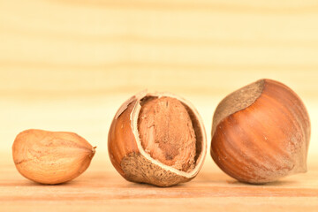 Hazelnuts, macro, on a background of natural wood.