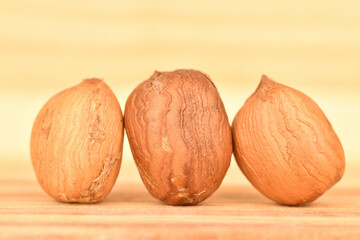 Hazelnuts, macro, on a background of natural wood.
