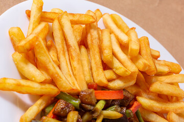 A nice plate of roasted chicken, seasoned with herbs, pepper, salt, oregano, and garlic. Also accompanied by vegetables fried on olive oil.
Accompanied by French fries on a white plate.