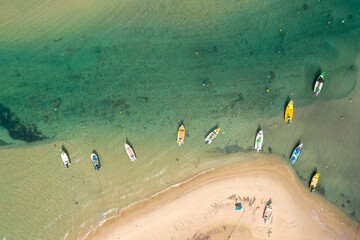 Small Fishing Boats anchored in a shallow lagoon, with packed Fish net onboard, Aerial image.