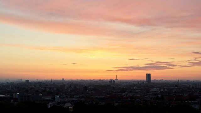 Sunset sky over silhouetted cityscape, Berlin, Germany
