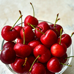 Glass bowl with ripe cherries. View from above. Close-up.